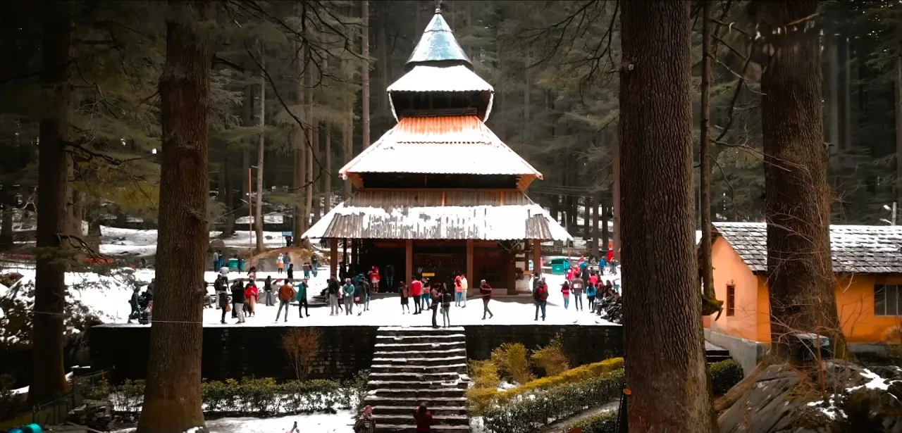 Hadimba Devi Temple in Manali among tall deodar trees and snow